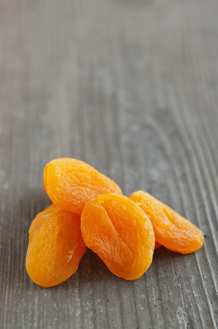 Dried apricots on a wooden surface