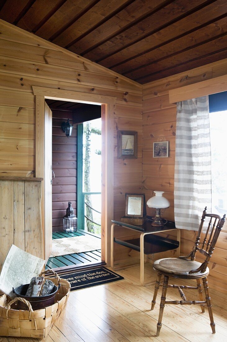 Entrance area of Finnish wooden house with lettered doormat on threshold