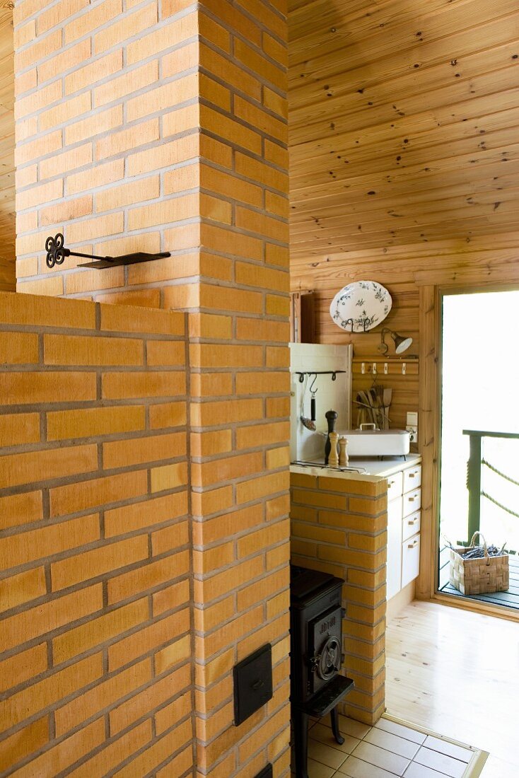 Black stove between chimney breast and partition