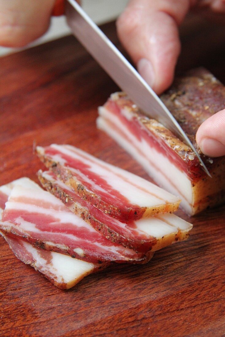 Pork belly being sliced