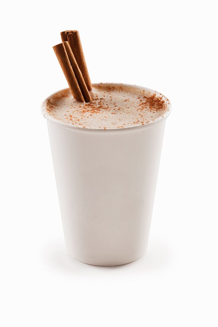 Cinnamon Cappuccino in a Paper Cup with Cinnamon Sticks; White Background