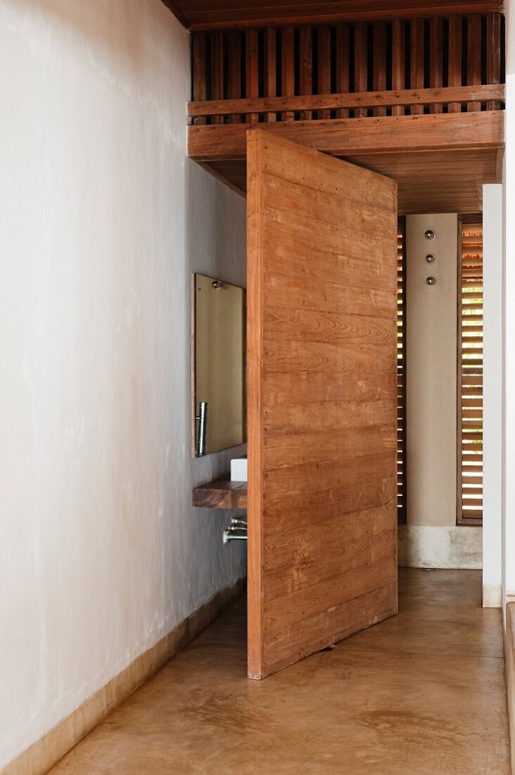 Concealed sink and mirror behind wall partition in Goan beach house, India