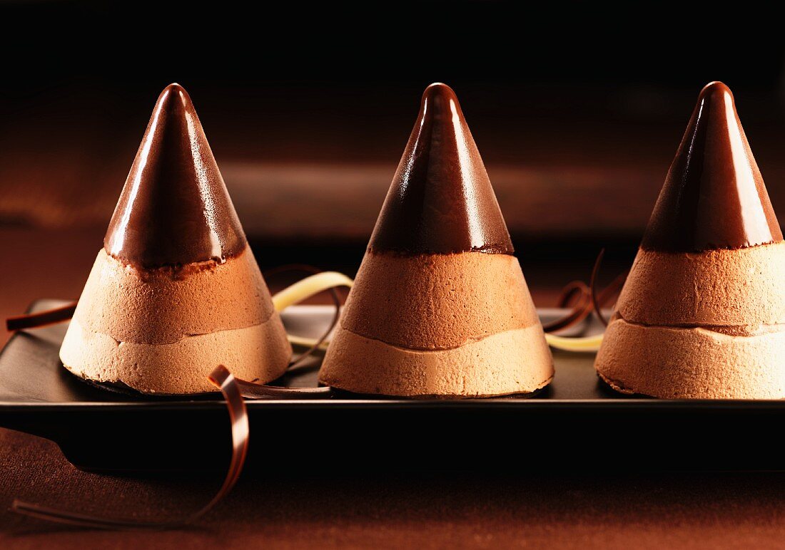 Frozen chocolate mousse towers with chocolate sauce