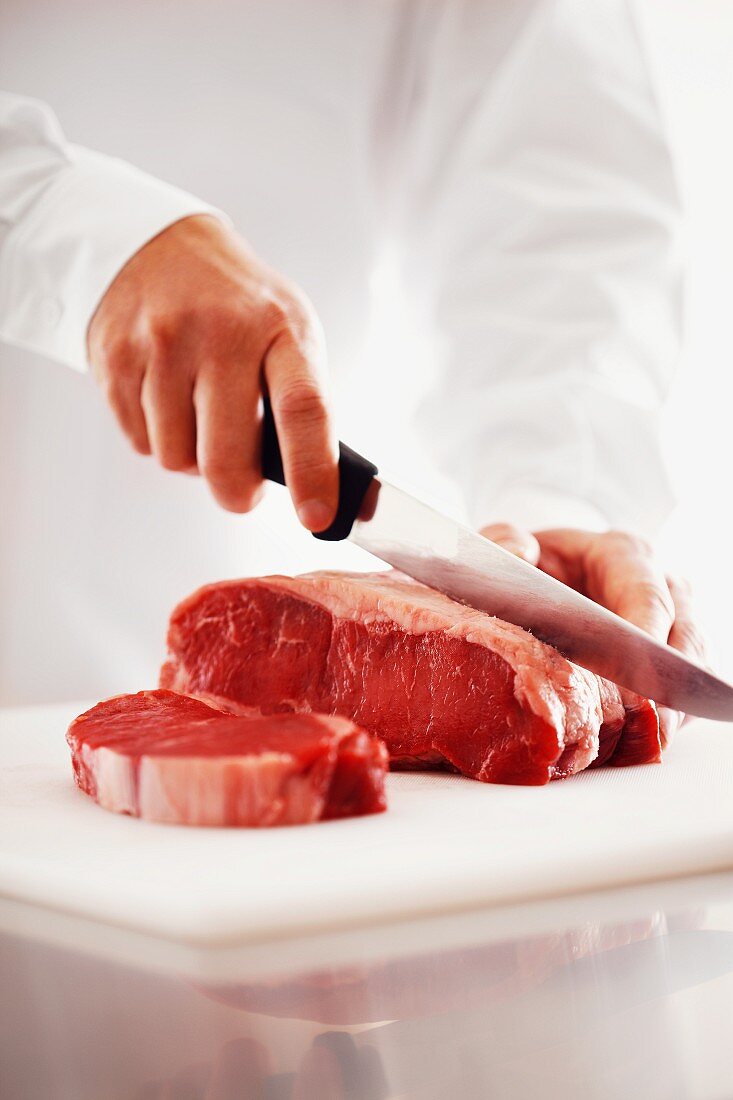 Rib-eye steaks being cut