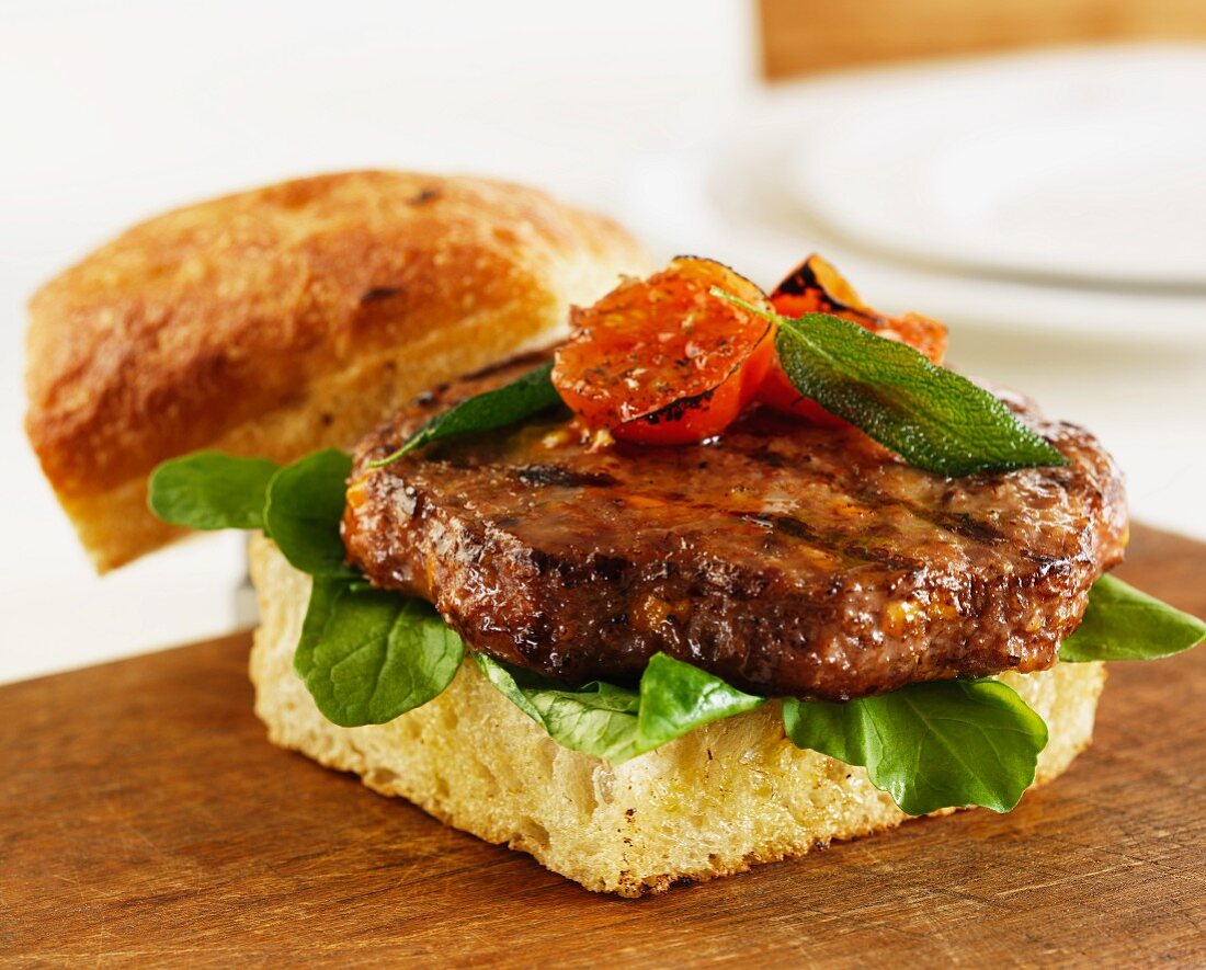 A bacon and cheddar burger with sage leaves