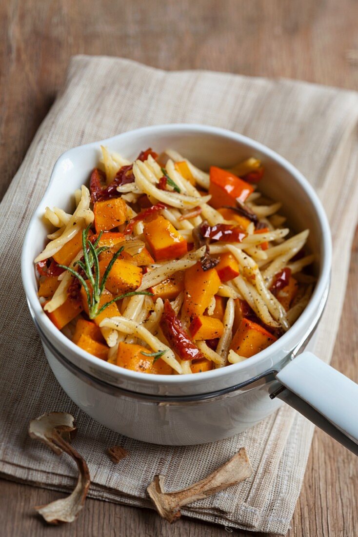 A pumpkin medley with pasta, dried tomatoes and porcini mushrooms