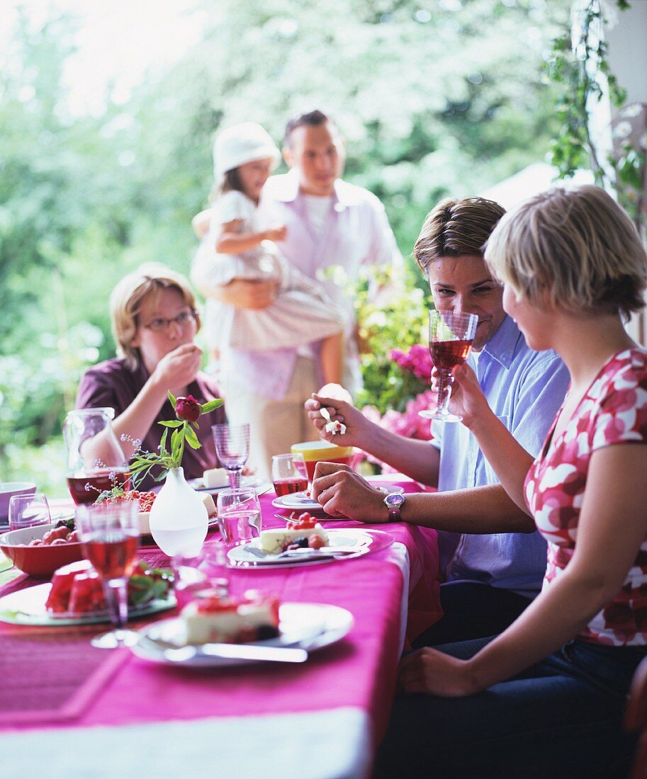 Dining with friend on a garden terrace