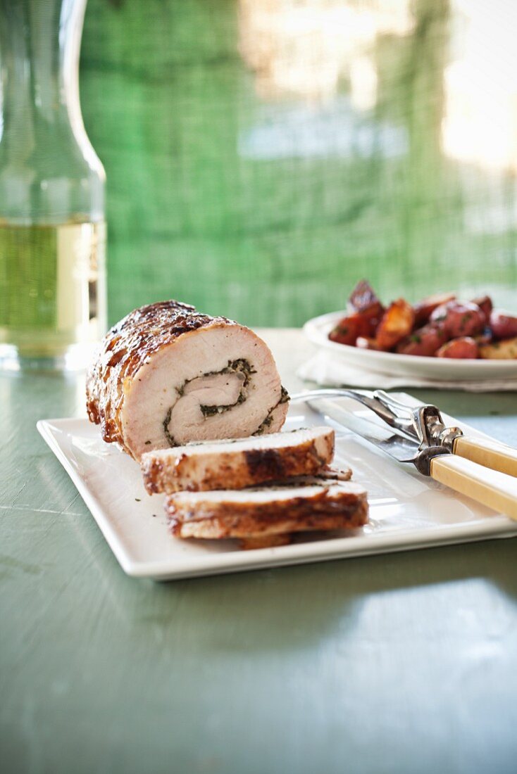 Rosemary Garlic Stuffed Rolled Pork; Sliced on a Platter