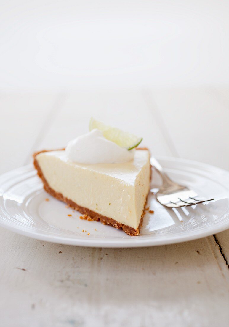 Slice of Key Lime Pie on a White Plate with a Fork