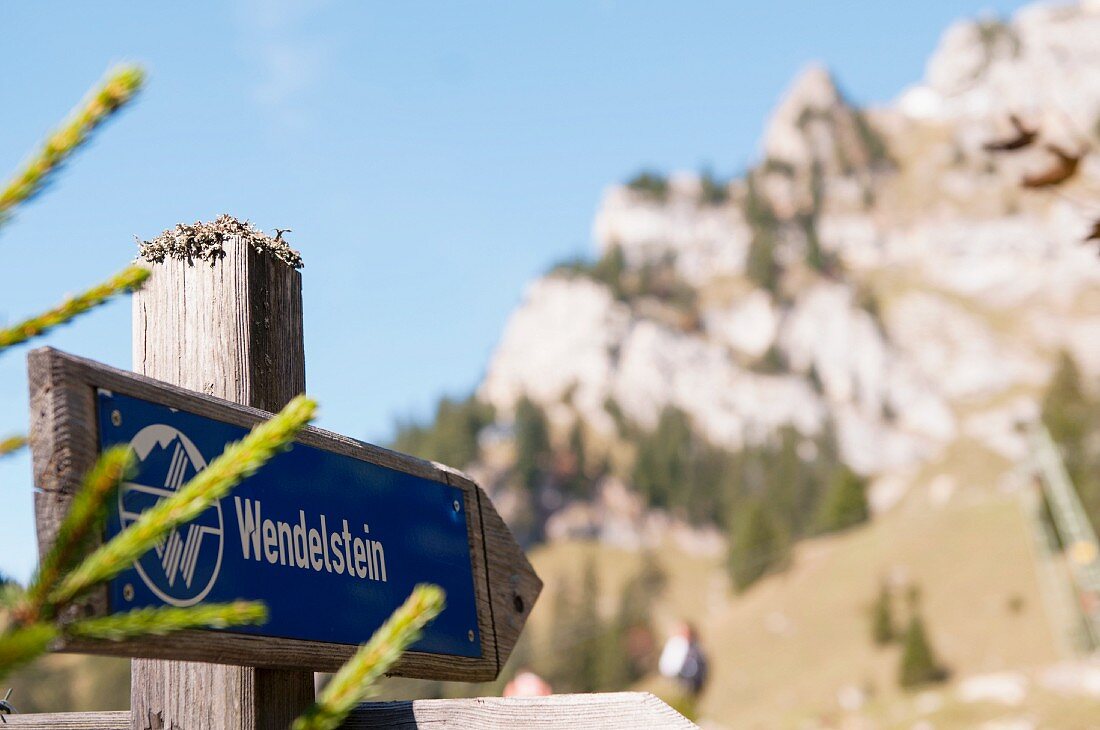Wooden trail marker pointing the way to the Wendelstein