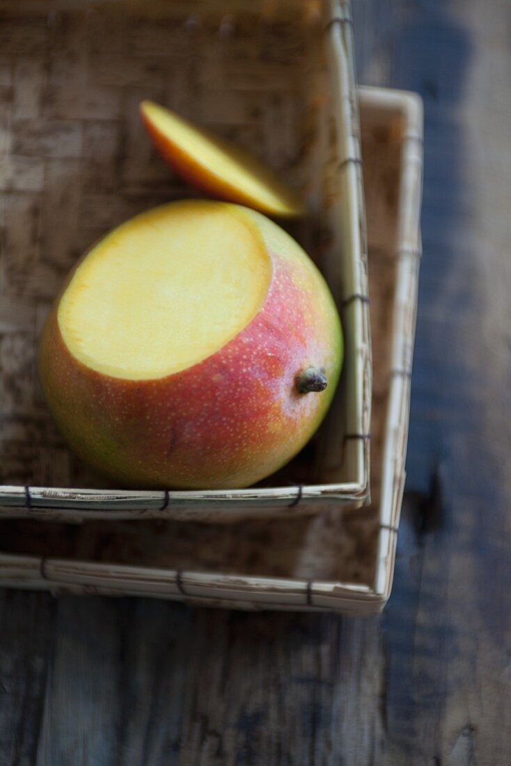 A sliced mango in a basket