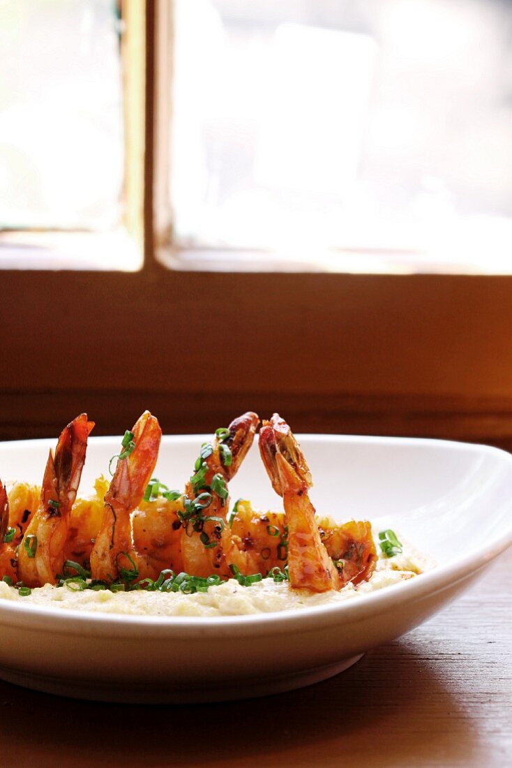 Sauteed Shrimp on Stone Ground White Grits Served with Spicy Tasso Sherry Cream