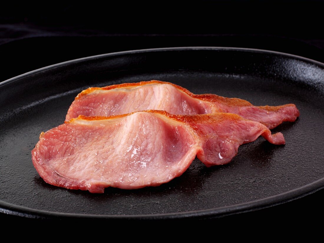 Rashers of bacon in a pan
