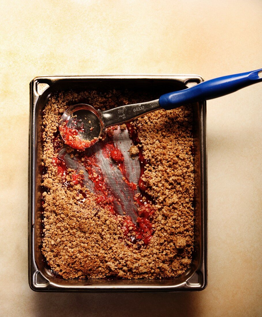 Cherry Cobbler with a Crumb Topping and a Serving Spoon; Scoops Removed
