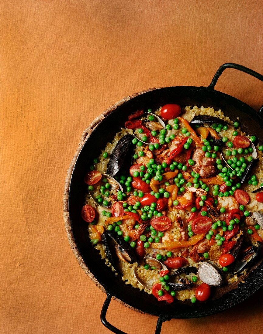 Paella in a Skillet; From Above; On Orange Background
