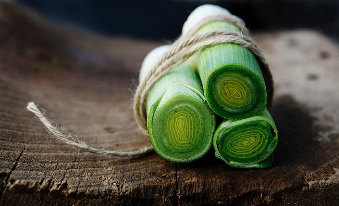 Leeks Tied in Twine on Rustic Wood