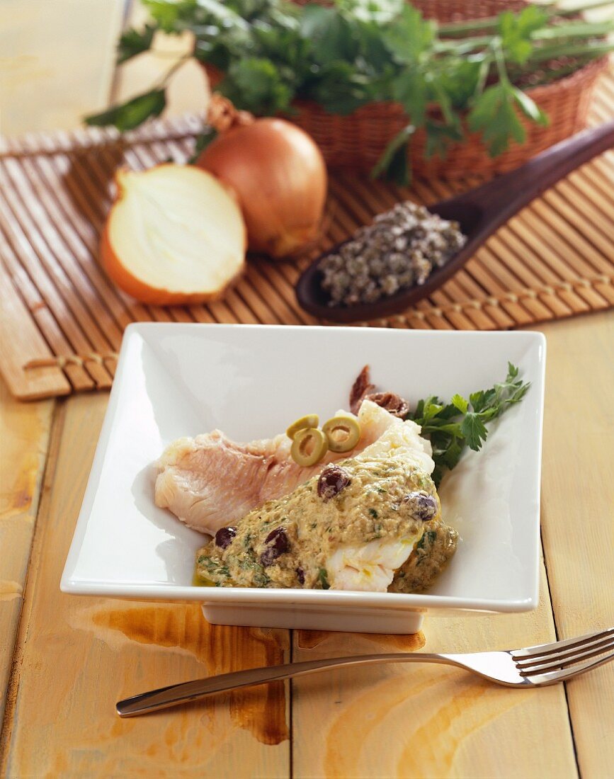 Hake with an olive and caper sauce