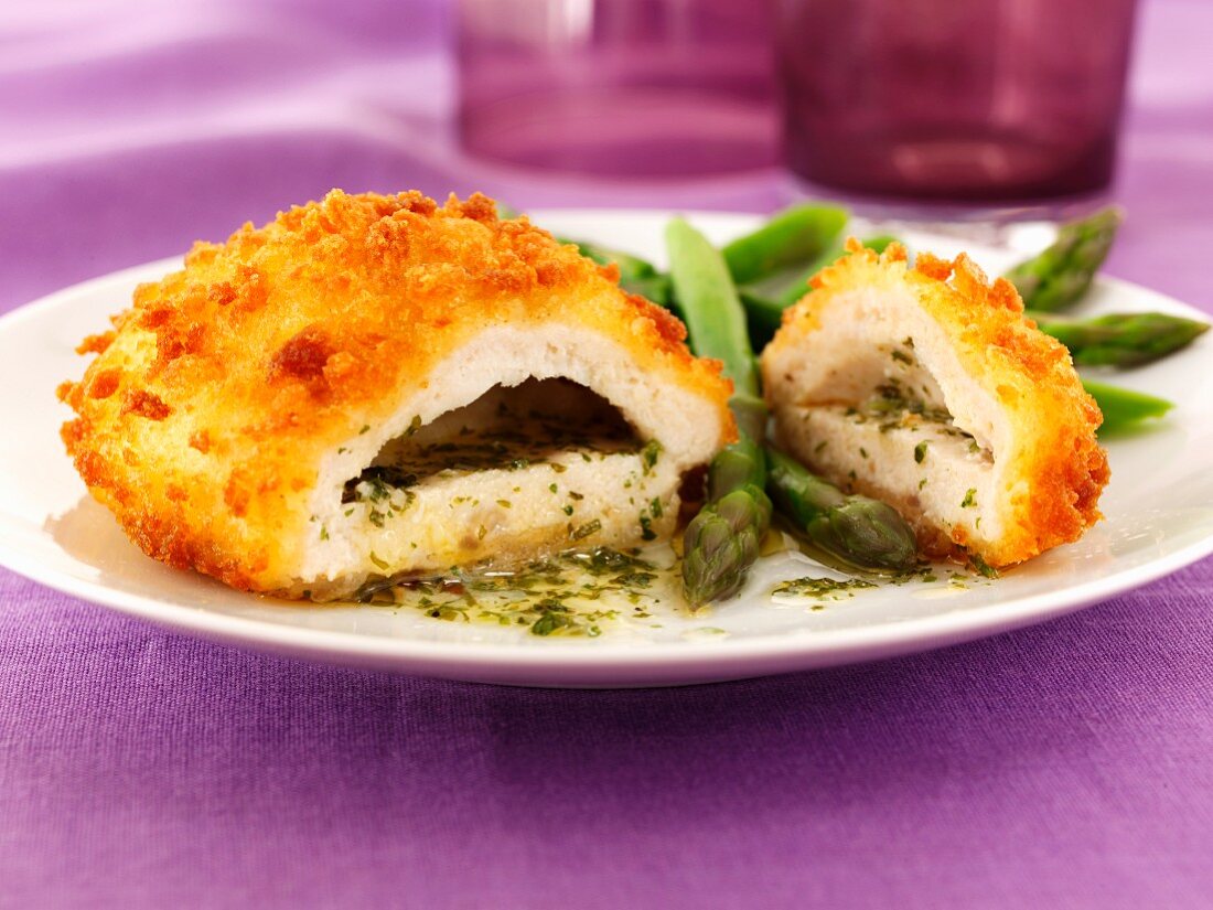Chicken kiev with garlic butter, herbs and asparagus