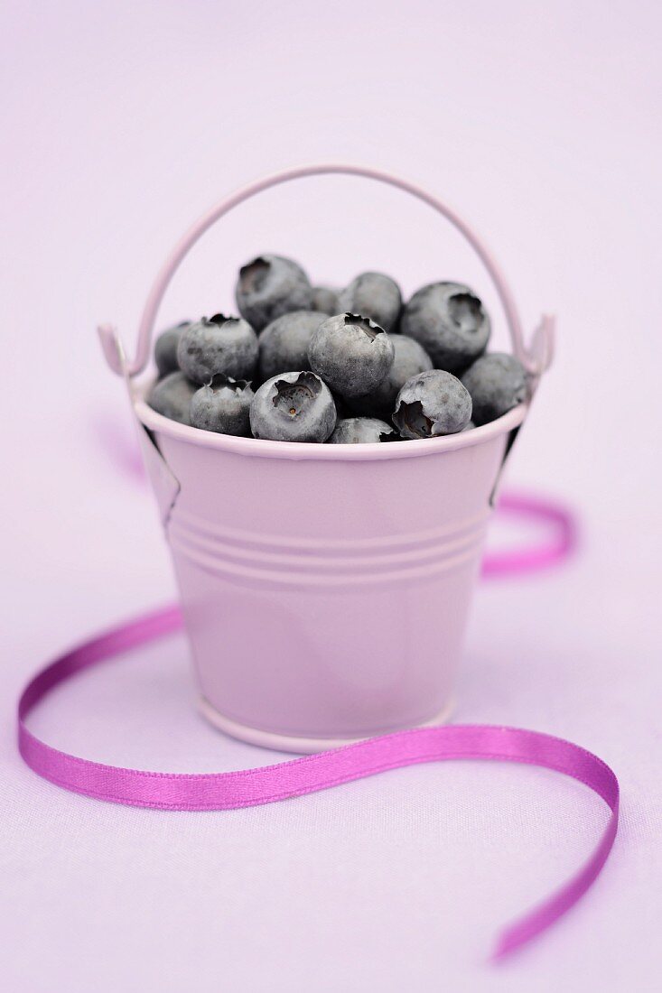 Blueberries in a purple bucket