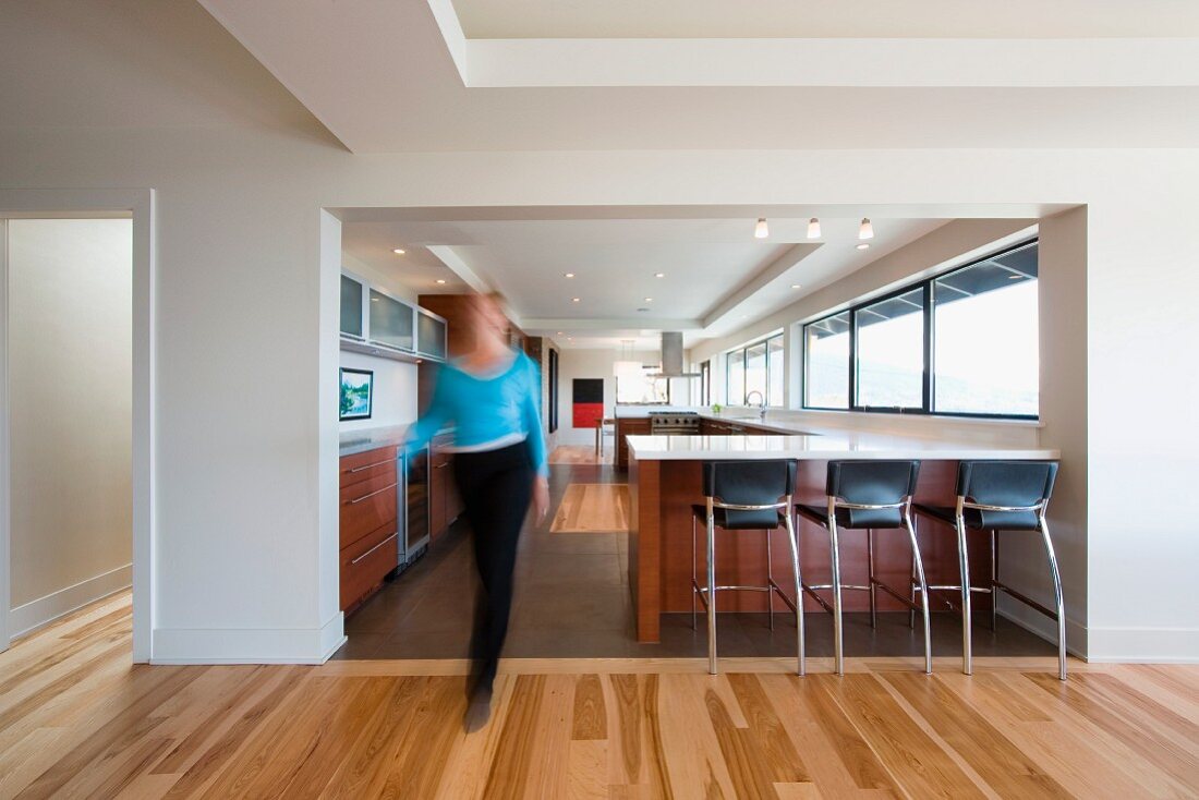 Woman walking through kitchen