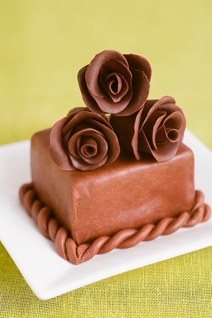 A cake decorated with chocolate roses