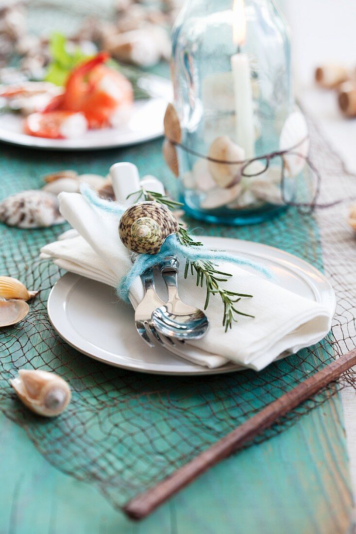 Place setting with seashells and rosemary
