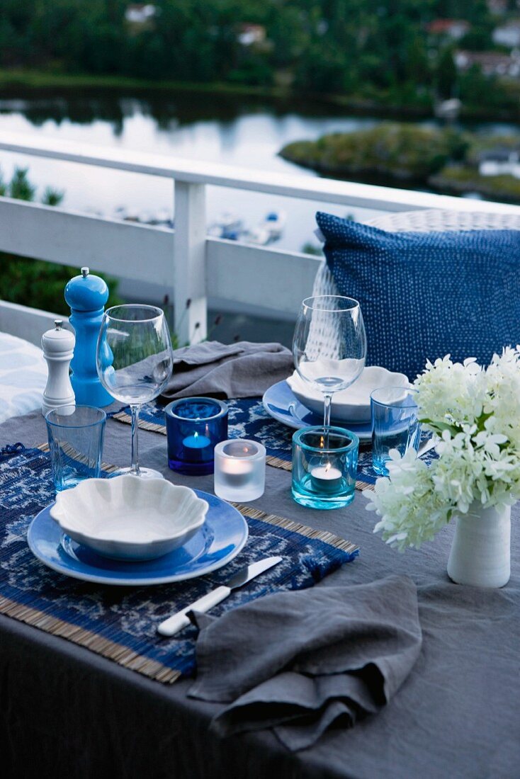 A table laid for a meal on raised decking