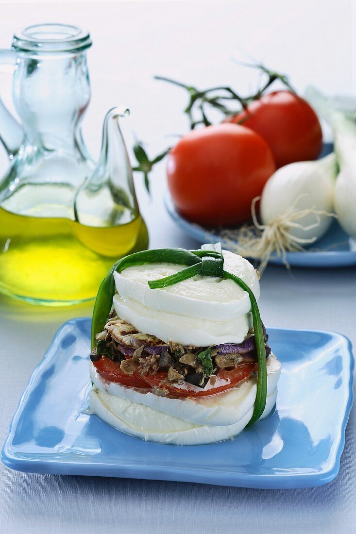 Vegetables sandwiched between two mozzarella slices