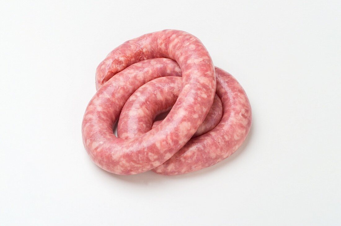 A raw coiled sausage
