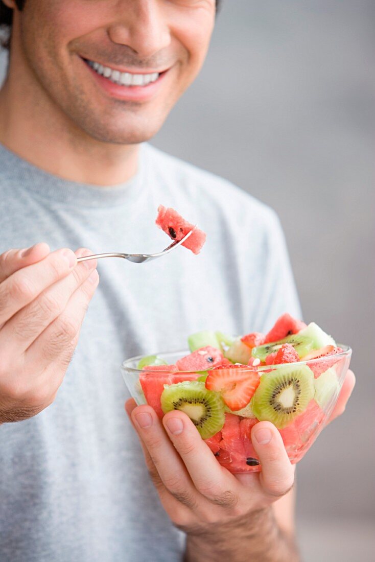 Man eating a fruit salad