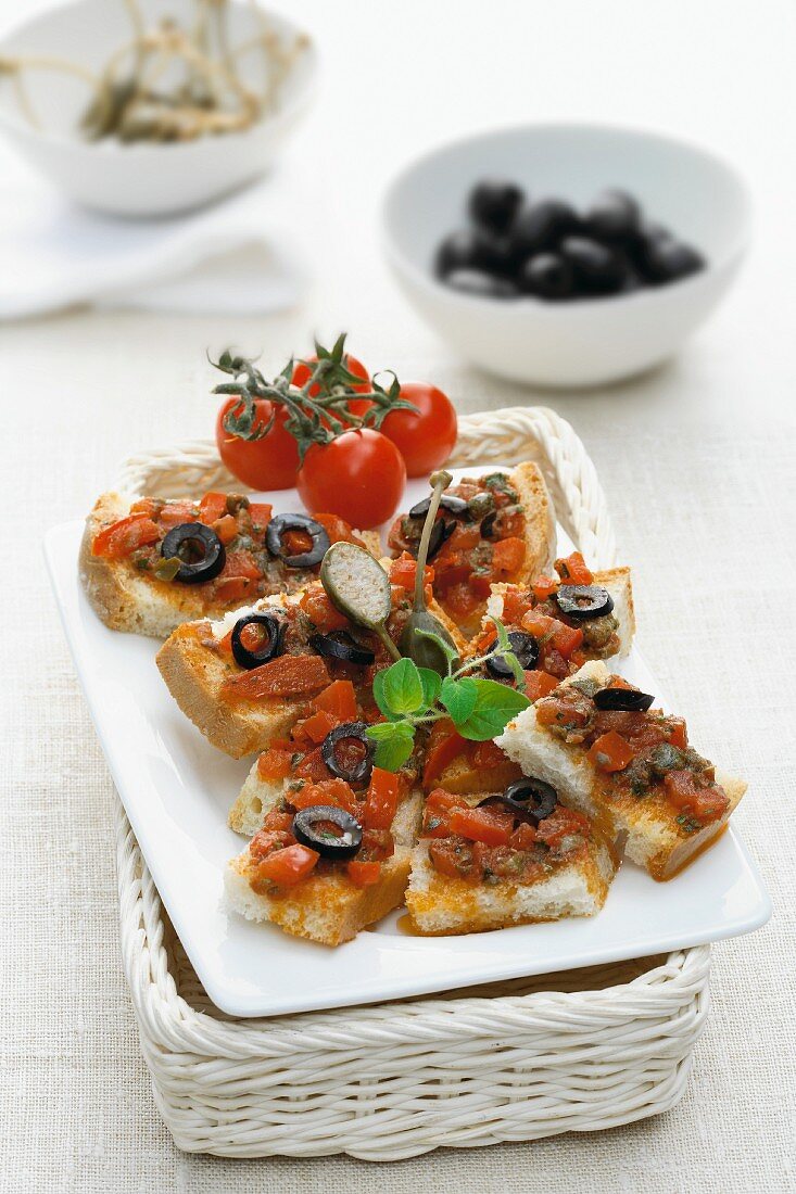 Crostini topped with tomatoes and olives