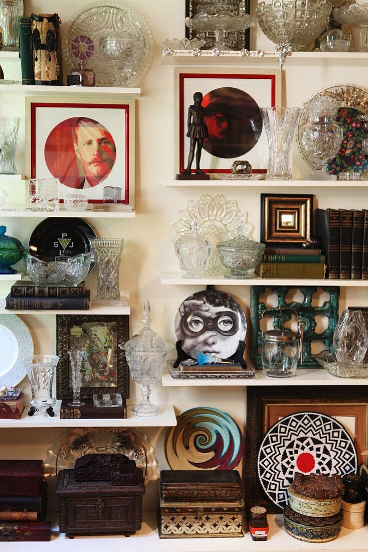 Floating shelves stiffed with various ornaments and crystal vases