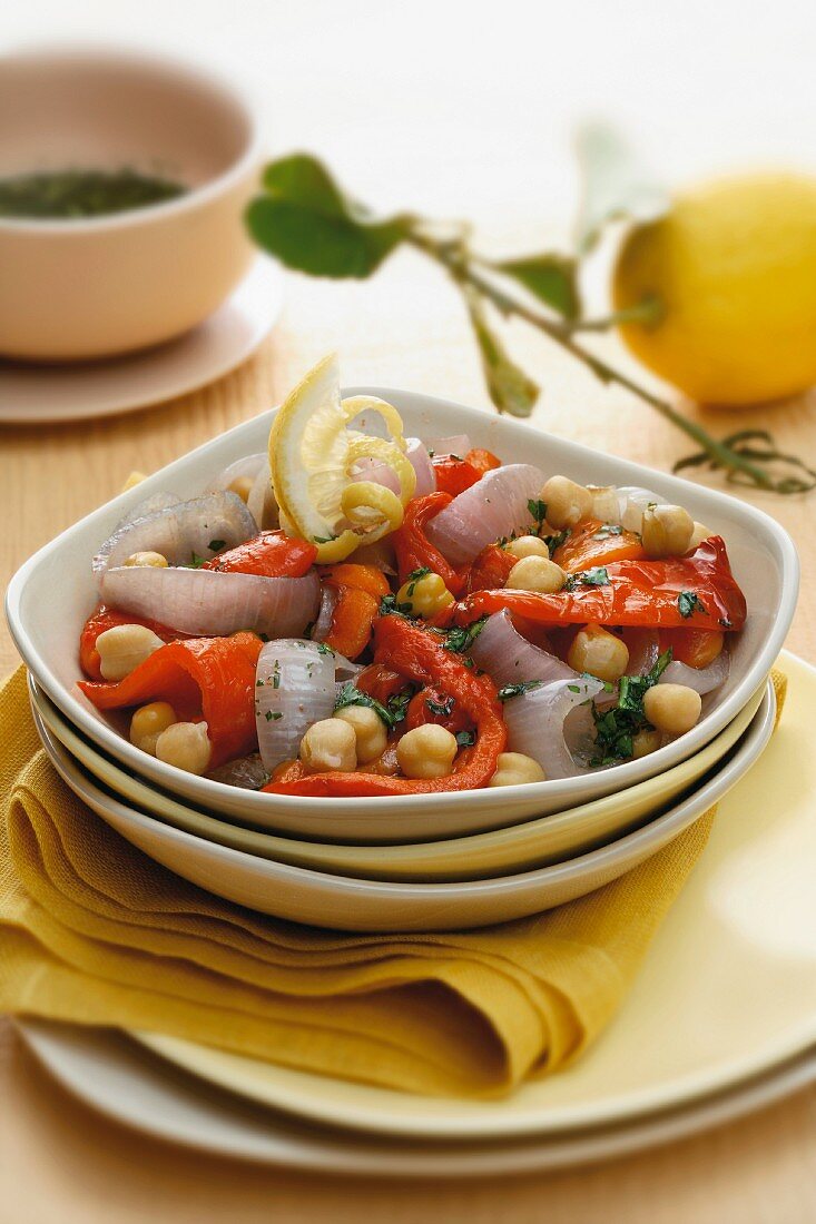 Vegetable salad with peppers, onions, cherry tomatoes and lemon