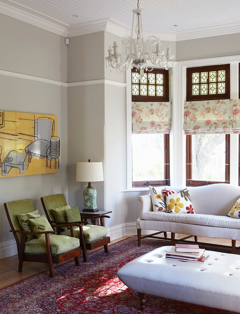 Lounge area with upholstered seating and coffee table in traditional setting with bay window