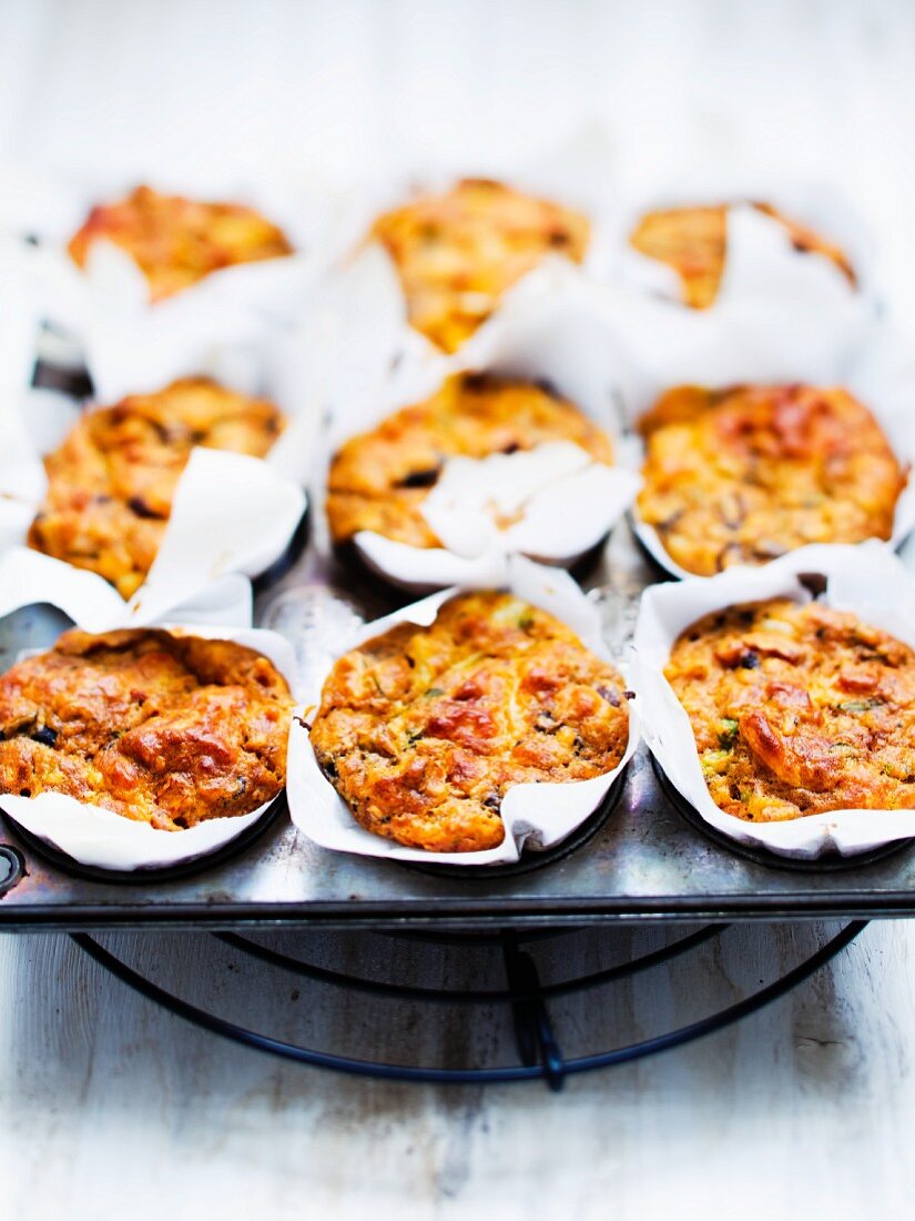 Spicy cheese and tomato muffins in a muffin tin