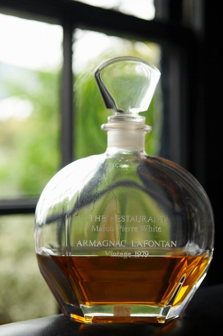 A bottle of Armagnac in a window