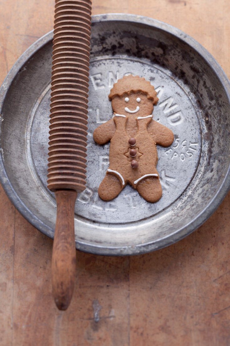 A gingerbread man on a metal plate