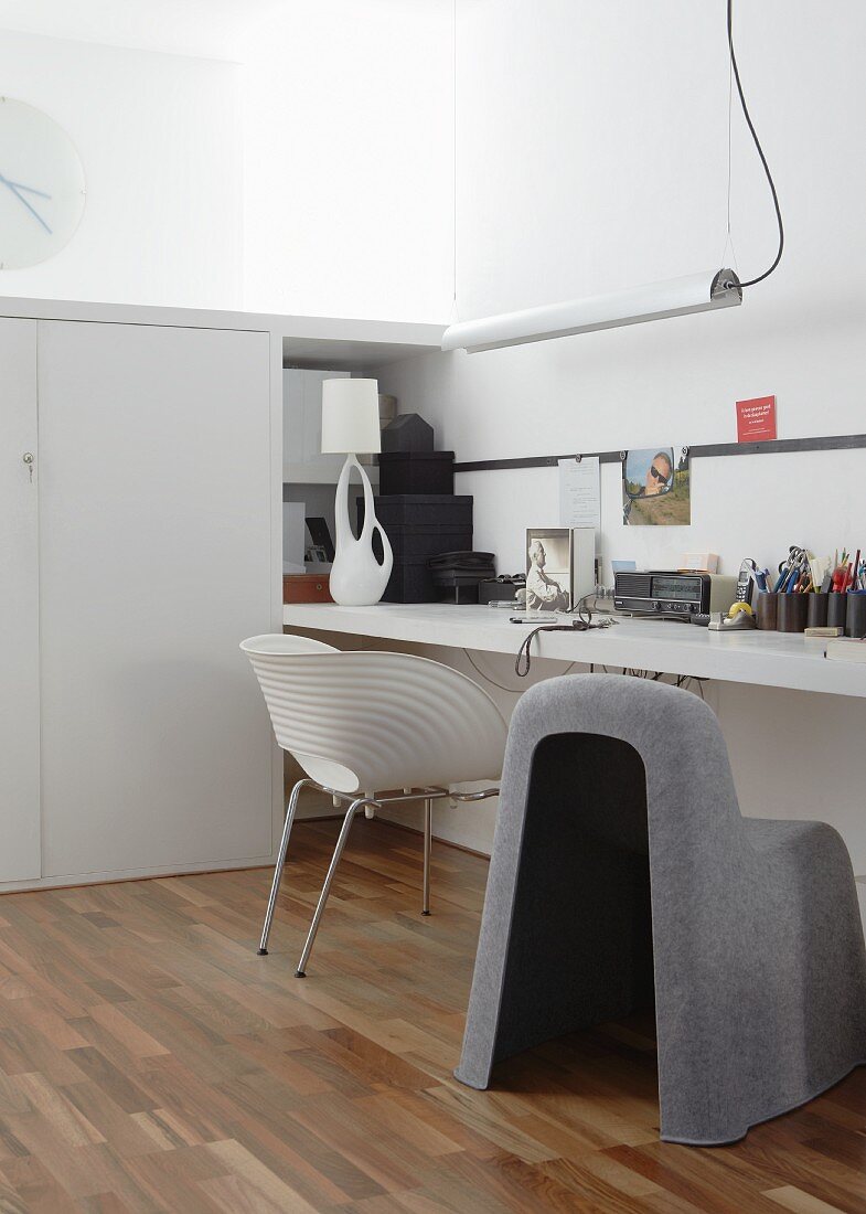 Home office with custom furniture and classic designer chairs