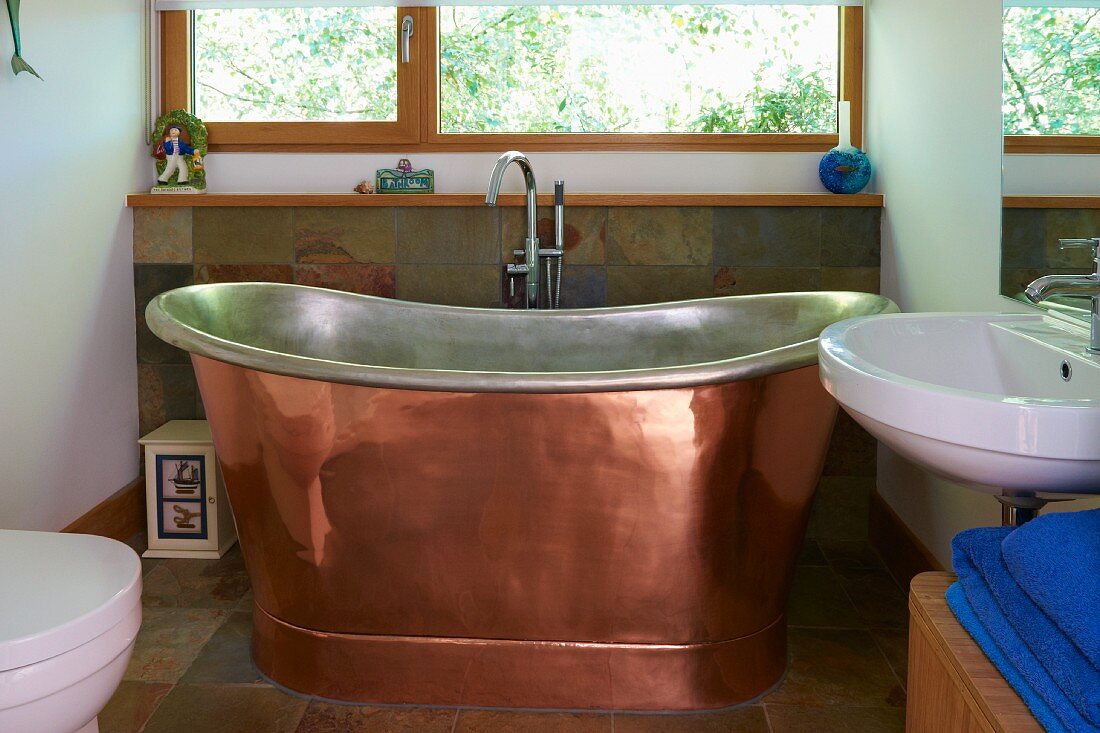 Free-standing copper bathtub in modern bathroom