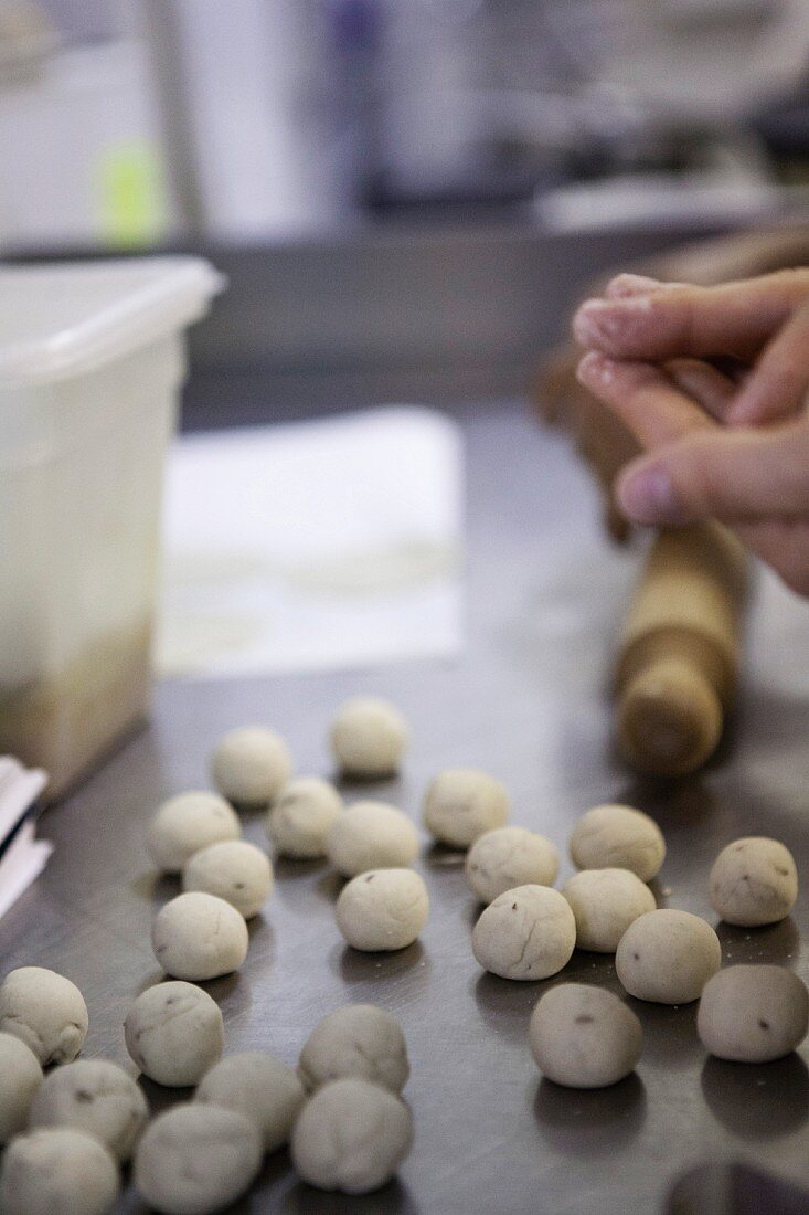 Small dough balls being shaped