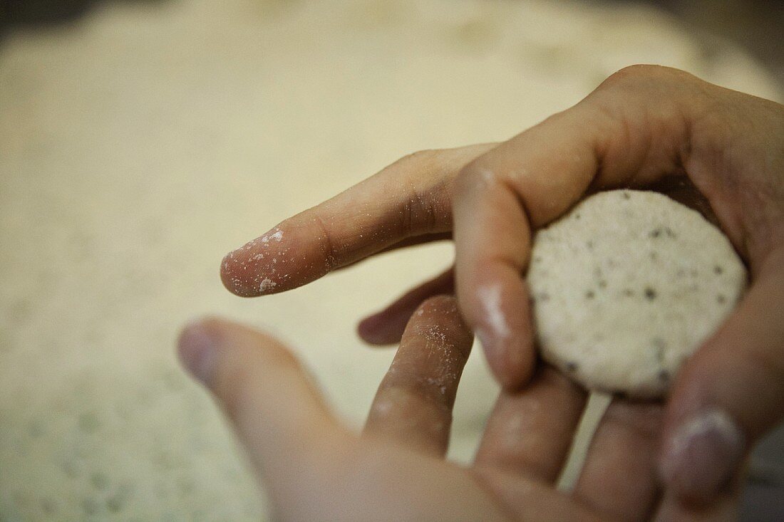 A small dough ball being formed