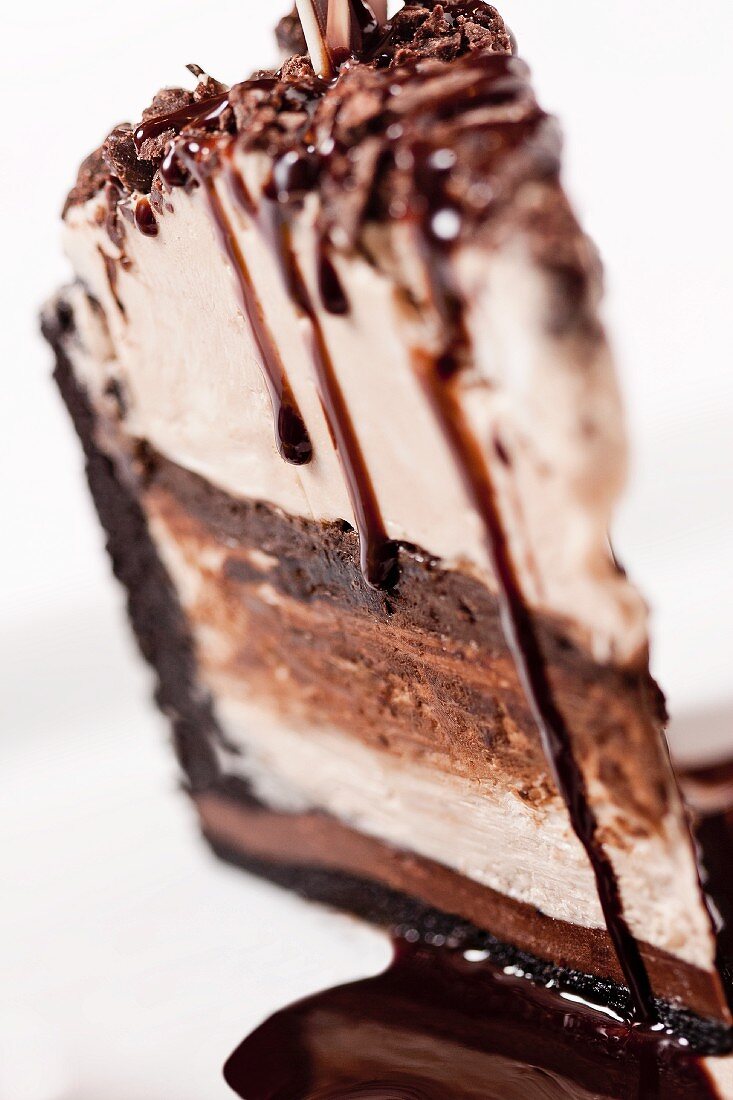 A Slice of Chocolate and Vanilla Ice Cream Cake with Chocolate Syrup
