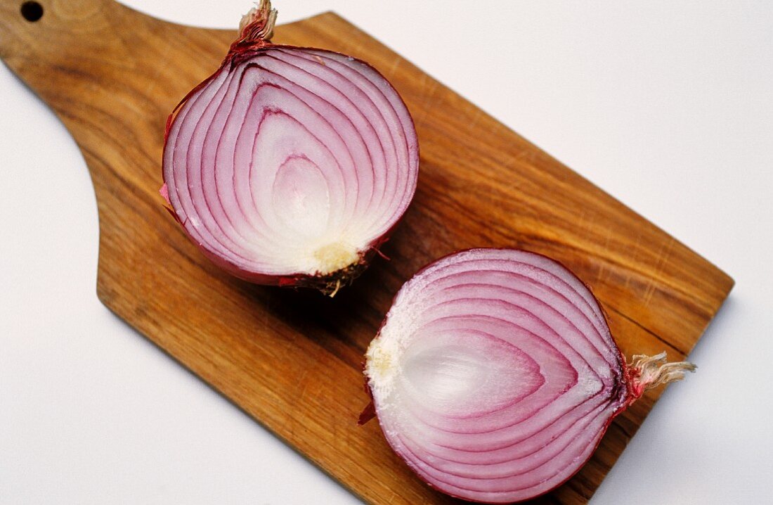Sliced red onion on chopping board