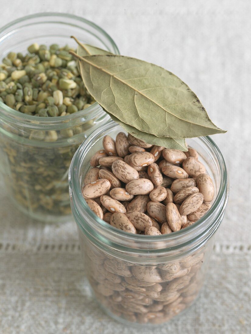 Two Jars of Dried Beans; Pinto Beans and Mung Beans; Bay Leaves on Top