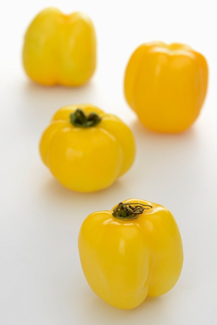 Four yellow pepper tomato peppers