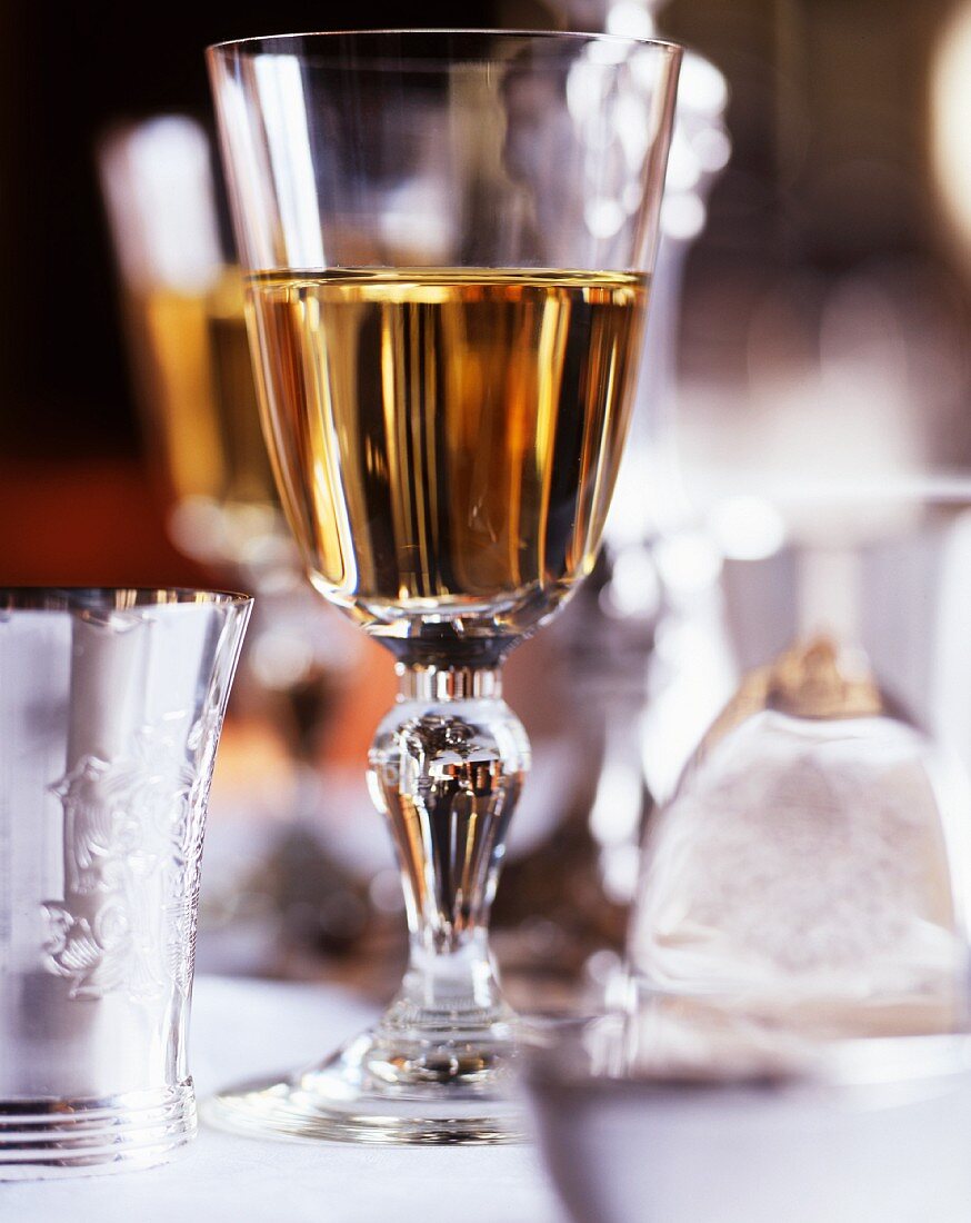 Glass of white wine on table laid for special occasion