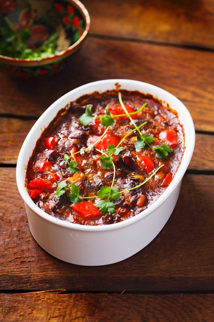 Chilli con carne in a baking dish with fresh herbs