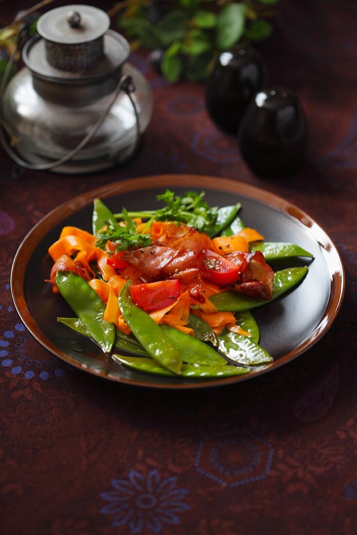 Fried mange tout with carrots and crispy bacon