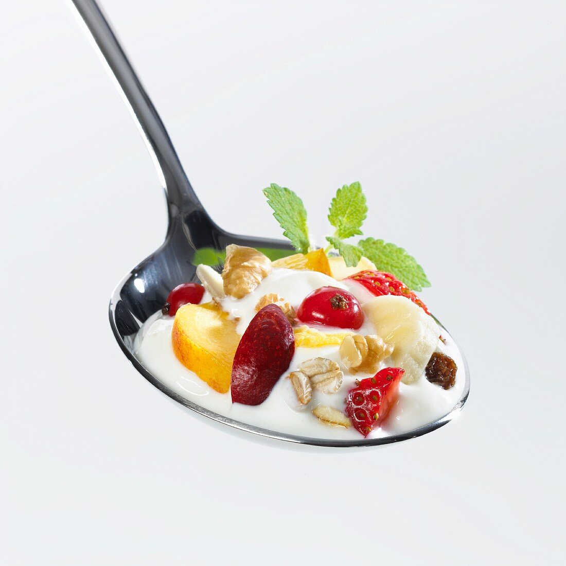 A spoonful of yoghurt muesli with fruit