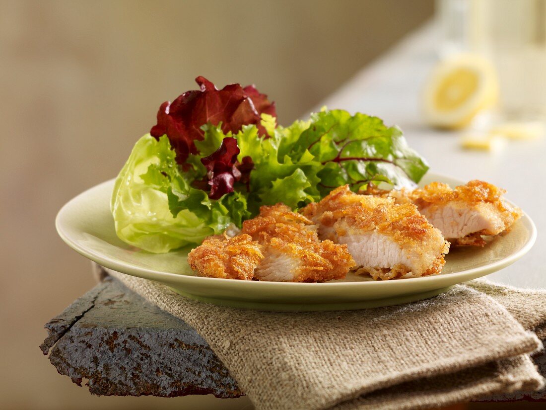 Turkey goujons with a cornflake crust and a mixed leaf salad